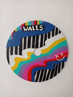 a multicolored wooden wall hanging with the word walls on it