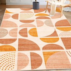 an orange and white rug with circles on it in a living room next to a chair