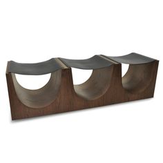 three wood and metal shelves with curved sections on each shelf, one in the middle