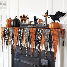 a fireplace decorated for halloween with decorations