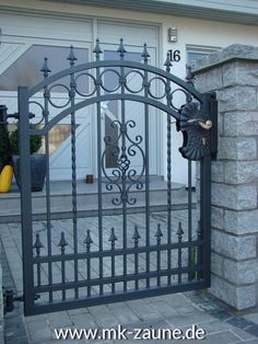 an iron gate in front of a house