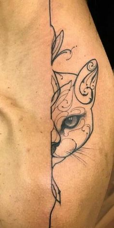 a close up of a person's stomach with a cat tattoo on it