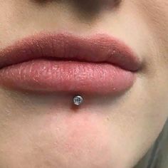 a woman's lips with a nose piercing