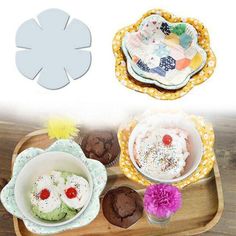 two plates with cupcakes and other desserts in them on a wooden tray