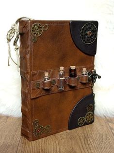 a brown leather book with six bottles in it