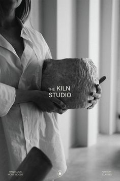 a woman holding an object with the words the kiln studio on it's side