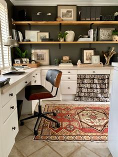 a home office with shelves and rugs on the floor