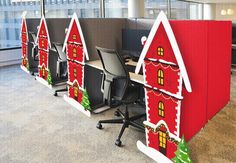 an office decorated for christmas with cubicles and desks in the shape of houses