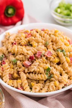 a white bowl filled with macaroni salad on top of a table