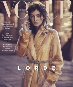 a woman in a trench coat on the cover of a magazine