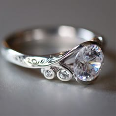 a white gold ring with an oval cut diamond