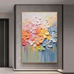 an abstract painting is hanging on the wall