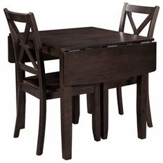 a wooden table and two chairs with one chair missing the back end, while the other is empty