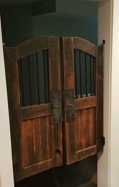 an old wooden door with bars on it