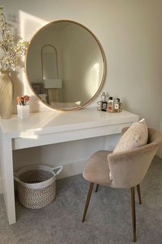 a white desk with a round mirror on it and a chair in front of it