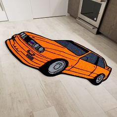 an orange car shaped rug on the floor