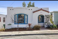 a white house with blue trim and windows