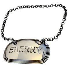 a silver dog tag with the word sheriff on it's side hanging from a chain