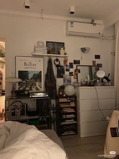 a bedroom with an air conditioner and pictures on the wall