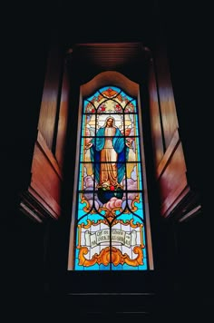 a stained glass window with the image of jesus on it