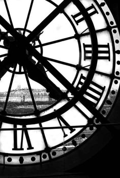 a large clock with roman numerals on it's face in black and white