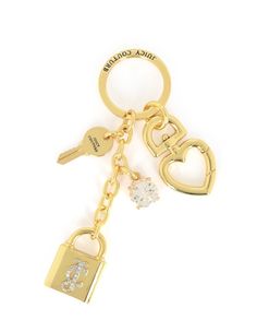 a gold keychain with two keys attached to it and a heart shaped lock