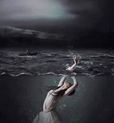 a woman floating in the water with her arms outstretched