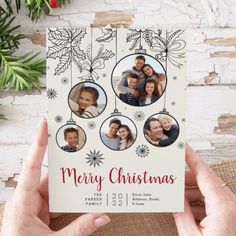 a person holding up a christmas card