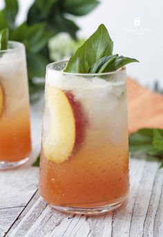 two glasses filled with peach basil spritzer