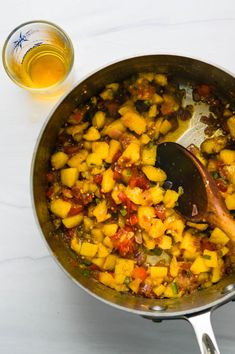 a pan filled with food and a wooden spoon