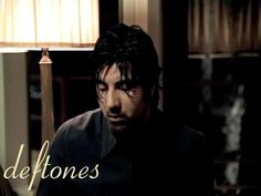 a man sitting in front of a lamp with the caption deftones on it