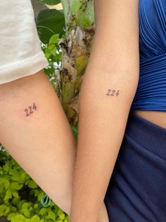 two people holding hands with numbers on them