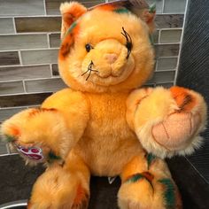 a yellow stuffed animal sitting on top of a counter