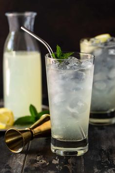 two glasses filled with ice, lemon and mint