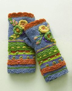 two knitted gloves with flowers on them