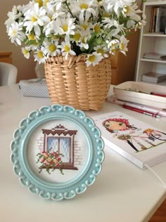 there is a small blue plate with flowers in it and a basket on the table