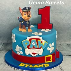 a birthday cake with a dog on top and paw patrol number one on the side