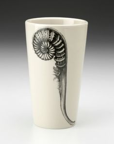 a white cup with a black and white design on it