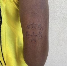 a person with a star tattoo on their left arm and the other arm behind him