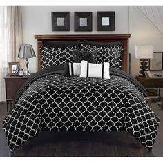 a bed with black and white comforters in a bedroom