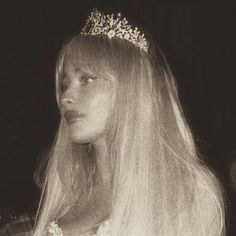 a woman with long blonde hair wearing a tiara