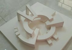 a white sculpture on top of a tile floor