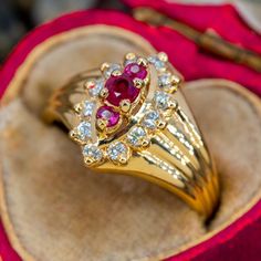 This elegant ring features rubies and diamonds and is crafted of 14k yellow gold. This ring is currently a size 5.5. One of the rubies is heavily chipped. Vintage Ruby Rings, Ruby Engagement Rings, Antique Gold Rings, Ruby Ring Vintage, Rubies And Diamonds, Ruby Wedding Rings, Ruby Diamond Ring, Ruby Rings, Ruby Diamond Rings