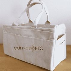 a canvas tote bag sitting on top of a wooden table