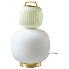 a white table lamp with a gold base