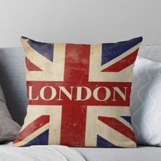 a british flag pillow with the word london on it in red, white and blue