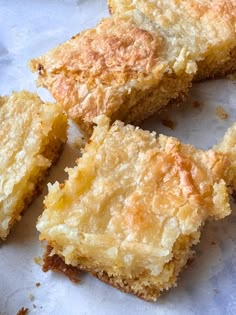 four pieces of cake sitting on top of a piece of paper with crumbs