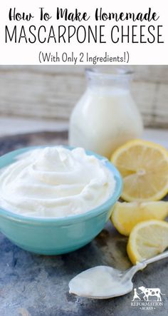 a blue bowl filled with whipped cream next to lemons and a jar of mayonnaise