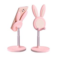 two pink bunny ears stand next to each other on top of metal bases, one with a phone in it's ear