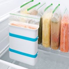 an open refrigerator filled with lots of different types of frozen food in plastic wrappers